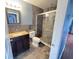 Bathroom features a vanity, toilet, and tiled walk-in shower with sliding glass doors at 804 Whitehurst Rd, Plant City, FL 33563
