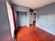 Bedroom with unique floors and a view of the doorway and window at 804 Whitehurst Rd, Plant City, FL 33563