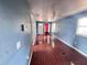 Foyer/hallway area featuring cherry-colored tile floors, ceiling fans and a front door at 804 Whitehurst Rd, Plant City, FL 33563