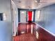 Living room featuring cherry-colored tile floors, ceiling fans and a front door at 804 Whitehurst Rd, Plant City, FL 33563