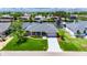 Beautiful waterfront home with lush green lawn and well-manicured landscaping at 829 Golf Island Dr, Apollo Beach, FL 33572