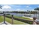 Backyard view of a serene canal, lush greenery and private boat dock create a tranquil waterfront retreat at 829 Golf Island Dr, Apollo Beach, FL 33572