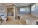 Bright bathroom featuring a soaking tub, shower, and mosaic tile accents, exuding a spa-like atmosphere at 829 Golf Island Dr, Apollo Beach, FL 33572