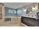 Bathroom with updated bath tub, glass shower and tiled accent wall at 829 Golf Island Dr, Apollo Beach, FL 33572