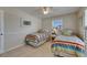 Comfortable bedroom with twin beds, tile floors and natural light at 829 Golf Island Dr, Apollo Beach, FL 33572