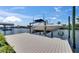 Private boat dock with boat lift, providing convenience for boat storage and maintenance at 829 Golf Island Dr, Apollo Beach, FL 33572