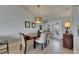 Elegant dining room with modern lighting, neutral colors, and tile floors at 829 Golf Island Dr, Apollo Beach, FL 33572