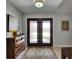 Welcoming foyer featuring elegant double doors, decorative rug, and stylish lighting fixture at 829 Golf Island Dr, Apollo Beach, FL 33572