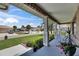 Charming front porch with elegant columns and views of the beautifully landscaped front yard at 829 Golf Island Dr, Apollo Beach, FL 33572