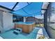 Outdoor hot tub situated on a covered deck, perfect for relaxation and enjoying the water views at 829 Golf Island Dr, Apollo Beach, FL 33572