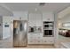 Contemporary kitchen with stainless steel refrigerator, oven, and white cabinetry at 829 Golf Island Dr, Apollo Beach, FL 33572