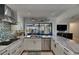 The open-concept kitchen is equipped with modern appliances, granite countertops, and a view of the backyard at 829 Golf Island Dr, Apollo Beach, FL 33572
