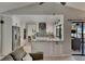 Open floor plan with view into the kitchen featuring a breakfast bar with granite countertops at 829 Golf Island Dr, Apollo Beach, FL 33572