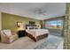 Comfortable main bedroom featuring an accent wall, ceiling fan, and access to the patio through sliding glass doors at 829 Golf Island Dr, Apollo Beach, FL 33572