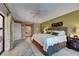 Comfortable main bedroom featuring an accent wall, ceiling fan, and access to the patio through sliding glass doors at 829 Golf Island Dr, Apollo Beach, FL 33572