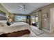 Comfortable main bedroom featuring an accent wall, ceiling fan, and access to the patio through sliding glass doors at 829 Golf Island Dr, Apollo Beach, FL 33572
