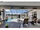 Spacious, covered outdoor area features a waterfront view, dining area, bar and grill at 829 Golf Island Dr, Apollo Beach, FL 33572