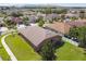 Overhead shot of house with spacious fenced yard in a residential area surrounded by other homes and mature trees at 8437 White Poplar Dr, Riverview, FL 33578