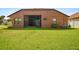 The backyard offers a screened patio and a lush green lawn, ideal for outdoor enjoyment and relaxation at 8437 White Poplar Dr, Riverview, FL 33578