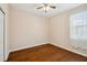 Bright bedroom with hardwood floors, neutral walls, and natural light at 8437 White Poplar Dr, Riverview, FL 33578