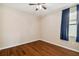 Comfortable bedroom with wood flooring, neutral walls, and large window at 8437 White Poplar Dr, Riverview, FL 33578