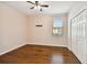 A well-lit bedroom featuring a ceiling fan, window with blinds, and a double door closet at 8437 White Poplar Dr, Riverview, FL 33578