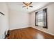 An empty bedroom with hardwood flooring, a ceiling fan, and a window with blinds, ready to be personalized at 8437 White Poplar Dr, Riverview, FL 33578
