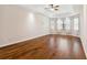 Spacious bedroom featuring tray ceiling, hardwood floors, and lots of natural light at 8437 White Poplar Dr, Riverview, FL 33578