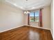 Formal dining area showcases hardwood floors, neutral paint and a decorative chandelier at 8437 White Poplar Dr, Riverview, FL 33578