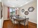 Elegant dining room features wood floors, tray ceilings, modern chandelier and decorative wall mirrors at 8437 White Poplar Dr, Riverview, FL 33578