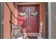 Charming double front door with decorative wreaths and a welcoming 'HOME' sign, creating a warm entrance at 8437 White Poplar Dr, Riverview, FL 33578