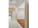 Open hallway featuring tiled flooring, arches, and views to a backyard, seamlessly connecting the living spaces at 8437 White Poplar Dr, Riverview, FL 33578