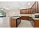 Open kitchen with a breakfast bar, stainless steel appliances, and wood cabinetry at 8437 White Poplar Dr, Riverview, FL 33578