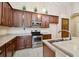 A kitchen showcasing stainless steel appliances and wood cabinets with modern countertops at 8437 White Poplar Dr, Riverview, FL 33578