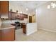 Modern kitchen featuring stainless steel appliances, dark cabinets and tile floors at 8437 White Poplar Dr, Riverview, FL 33578