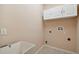 The laundry room includes a utility sink and white cabinets for storage at 8437 White Poplar Dr, Riverview, FL 33578