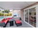 Outdoor patio area offering a relaxing space with comfortable seating and a view of the pool at 9715 Pleasant Run Way, Tampa, FL 33647