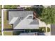 An overhead shot reveals the dark gray roof and the surrounding landscaping features of this home at 9954 N Jasmine Brook E Cir, Land O Lakes, FL 34638