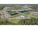 This aerial image highlights a community pool, playground and ponds nestled within this charming neighborhood at 9954 N Jasmine Brook E Cir, Land O Lakes, FL 34638