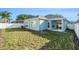 This home has a spacious backyard with a white fence for privacy, a covered patio, and an air conditioning unit at 9954 N Jasmine Brook E Cir, Land O Lakes, FL 34638