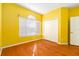 Bright bedroom featuring hardwood floors, natural light, and a closet for storage at 9954 N Jasmine Brook E Cir, Land O Lakes, FL 34638