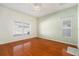 The bedroom features hardwood floors, two windows, and a ceiling fan at 9954 N Jasmine Brook E Cir, Land O Lakes, FL 34638