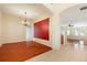 The dining room features hardwood floors and a red accent wall at 9954 N Jasmine Brook E Cir, Land O Lakes, FL 34638