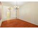Dining room features hardwood floors and an elegant chandelier at 9954 N Jasmine Brook E Cir, Land O Lakes, FL 34638