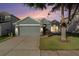 Charming single-story home featuring a well-manicured lawn and an attached two-car garage at 9954 N Jasmine Brook E Cir, Land O Lakes, FL 34638