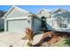 Close up of a light blue single-story home with a driveway and well landscaped yard at 9954 N Jasmine Brook E Cir, Land O Lakes, FL 34638