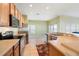 The kitchen features stainless steel appliances, tile flooring, and a breakfast bar at 9954 N Jasmine Brook E Cir, Land O Lakes, FL 34638