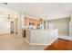 Open kitchen with stainless steel appliances, tile backsplash, breakfast bar, and tile flooring at 9954 N Jasmine Brook E Cir, Land O Lakes, FL 34638