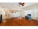 Comfortable living room featuring hardwood floors and a view to the dining room and kitchen at 9954 N Jasmine Brook E Cir, Land O Lakes, FL 34638