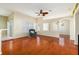 Spacious living room with hardwood floors, a ceiling fan, and natural light from the windows at 9954 N Jasmine Brook E Cir, Land O Lakes, FL 34638